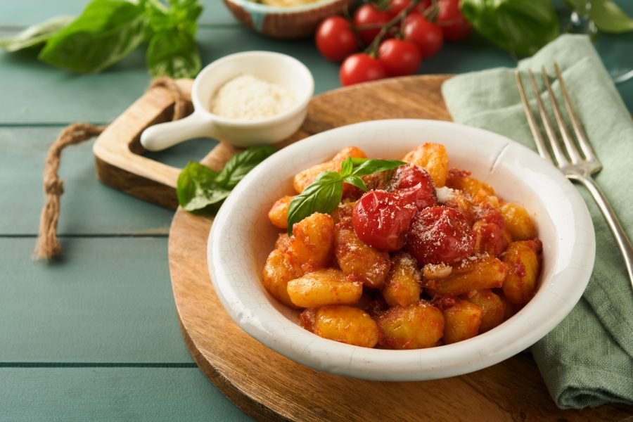 Potato gnocchi. Traditional homemade potato gnocchi with tomato sauce, basil and parmesan cheese on